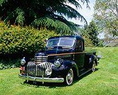 AUT 14 RK1069 01
1941 Chevrolet 1-Ton Pickup Truck Black And Gold 3/4 Front View On Grass By Trees