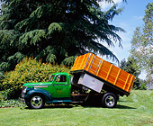 AUT 14 RK1079 01
1946 Chevy 4400 1 1/2 Ton Dump Truck Green 3/4 Side View On Grass Trees Background