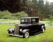AUT 14 RK1085 01
1934 Ford Pickup Truck Black 3/4 Front View On Grass By Fence