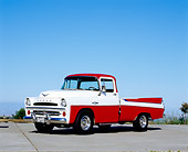 AUT 14 RK1091 03
1957 Dodge Sweptside Red And White Pick Up Truck 3/4 Side View On Pavement Blue Sky