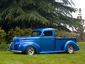 AUT 14 RK1135 01
1940 Ford Pick Up Truck Teal 3/4 Side View On Grass By Trees