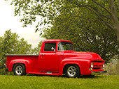 AUT 14 RK1144 01
1956 Ford F-100 Pick Up Truck Red 3/4 Side View On Grass By Trees