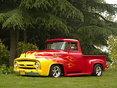 AUT 14 RK1152 01
1956 Ford F-100 1/2 Ton Pick Up Truck Red With Flames 3/4 Side View On Grass By Trees