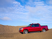 AUT 14 RK1179 01
2007 Ford Explorer Sport Trac Pick Up Truck Red 3/4 Front View On Sand Hill