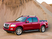AUT 14 RK1181 01
2007 Ford Explorer Sport Trac Pick Up Truck Red 3/4 Side View On Sand