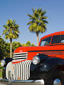 AUT 14 RK1205 01
1946 Chevrolet CK 1/2 Ton Red And Black Pick Up Truck 3/4 Front View Detail By Palm Trees