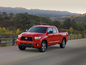 AUT 14 RK1248 01
2007 Toyota Tundra Double Cab SR5 Red 3/4 Front View On Pavement By Hills At Dusk