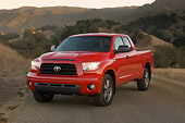 AUT 14 RK1253 01
2007 Toyota Tundra Double Cab SR5 Red 3/4 Front View On Pavement By Hills At Dusk