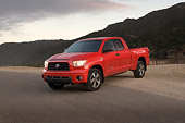 AUT 14 RK1255 01
2007 Toyota Tundra Double Cab SR5 Red 3/4 Front View On Pavement By Hills At Dusk