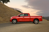 AUT 14 RK1257 01
2007 Toyota Tundra Double Cab SR5 Red Low Profile View On Pavement By Hills At Dusk