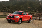 AUT 14 RK1258 01
2007 Toyota Tundra Double Cab SR5 Red 3/4 Front View On Dirt By Hills At Dusk