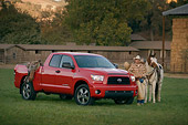 AUT 14 RK1268 03
2007 Toyota Tundra Double Cab SR5 Red 3/4 Side View On Grass By Wrangler And Horse