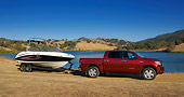 AUT 14 RK1282 01
2007 Toyota Tundra Crewmax Red Pearl 3/4 Front View With Boat On Sand By Water And Hills