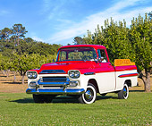 AUT 14 RK1389 01
1959 Chevrolet Apache Deluxe Pickup Truck Red And White 3/4 Front View On Grass By Trees