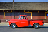 AUT 14 RK1406 01
1957 Chevrolet Stepside Pickup Truck Red Profile View On Pavement By Building