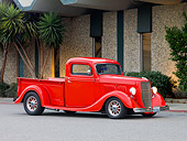 AUT 14 RK1423 01
1935 Ford Pickup Truck Red 3/4 Front View On Pavement By Building And Trees