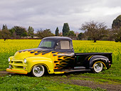 AUT 14 RK1460 01
1954 Chevrolet Pickup Truck Hot Rod Black With Yellow Flames 3/4 Front View In Field Of Yellow Wildflowers