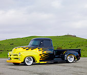 AUT 14 RK1465 01
1954 Chevrolet Pickup Truck Hot Rod Black With Yellow Flames 3/4 Front View On Pavement By Hills
