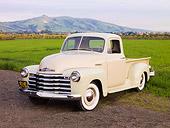 AUT 14 RK1479 01
1952 Chevrolet 3100 Pickup Truck Tan And Green 3/4 Front View On Dirt By Grass