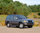 AUT 15 RK0164 03
1999 Lexus LX 470 Green 3/4 Front View On Pavement By Trees And Grass Hill