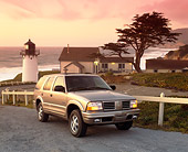 AUT 15 RK0292 16
2000 Oldsmobile Bravada Pewter 3/4 Front View By Lighthouse And Ocean Clouds Parking Lights On
