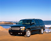 AUT 15 RK0588 09
2002 GMC Denali Canepa Design LE Black 3/4 Front View On Sand By Ocean