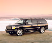 AUT 15 RK0595 04
2002 GMC Denali Canepa Design LE Black 3/4 Front View On Sand By Ocean Filtered