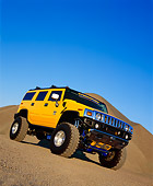 AUT 15 RK0667 03
2003 H2 Hummer Lifted Yellow Slanted Low 3/4 Front View On Dirt Hill Blue Sky