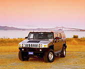 AUT 15 RK0727 04
2003 Hummer H2 Pewter Metallic 3/4 Front View On Dry Grass Water With Bridge Filtered