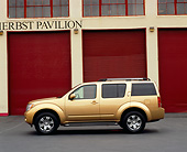 AUT 15 RK0789 01
2005 Nissan Pathfinder Gold Profile View On Pavement By Garage Doors