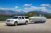 AUT 15 RK1228 01
2011 Yukon Denali White With 226 Cobalt Boat 3/4 Front View On Pavement By Mountains