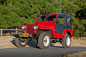 AUT 15 RK1233 01
1947 Jeep CJ-2A Red With Black Top 3/4 Front View On Pavement By Fence And Trees