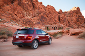 AUT 15 RK1258 01
2013 Ford Explorer Red 3/4 Rear View On Dirt Road By Red Rock