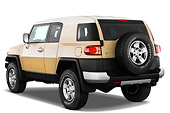 AUT 15 IZ0077 01
2013 Toyota FJ Cruiser Yellow 3/4 Rear View Studio