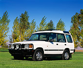 AUT 15 RK0008 04
1996 Land Rover Discovery White Low 3/4 Front View On Grass Trees Blue Sky