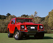AUT 15 RK0073 03
1990 Lamborghini LM002 Americana Red Low 3/4 Front View On Grass Blue Sky
