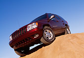 AUT 15 RK0124 05
1999 Jeep Grand Cherokee Limited Burgundy Slanted Low 3/4 Front View On Dirt Hill Blue Sky
