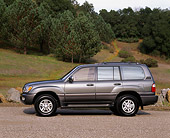 AUT 15 RK0166 06
1999 Lexus LX470 Green Profile View On Pavement By Grass Hill And Trees