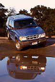 AUT 15 RK0227 05
1996 Ford Explorer Blue 3/4 Front View On Mud By Water Trees Background