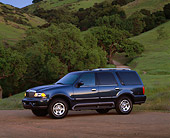AUT 15 RK0307 01
2000 Lincoln Navigator Blue Side 3/4 View On Dirt By Grass Hill And Trees At Dusk