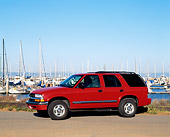 AUT 15 RK0310 01
2000 Chevrolet Blazer Red 3/4 Front View On Pavement By Harbor Blue Sky
