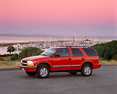 AUT 15 RK0314 03
2000 Chevrolet Blazer Red 3/4 Front View On Pavement Harbor Background