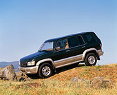 AUT 15 RK0338 09
2000 Isuzu Trooper Green 3/4 Front View On Grass Hill Blue Sky