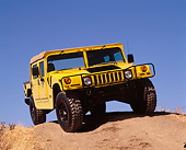 AUT 15 RK0351 06
2000 Hummer H1 Yellow 3/4 Front View On Dirt Hill Blue Sky