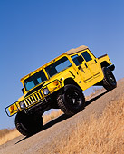AUT 15 RK0353 10
2000 Hummer H1 Competition Yellow Slanted Front 3/4 View On Pavement Hill Dry Grass Blue Sky