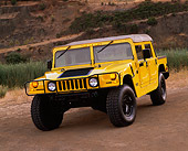 AUT 15 RK0372 02
2000 Hummer H1 Yellow 3/4 Front View On Dirt By Quarry