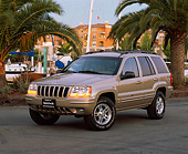 AUT 15 RK0380 04
2000 Jeep Grande Cherokee Limited Champagne 3/4 Front View On Pavement By Harbor And Palm Trees