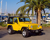AUT 15 RK0388 05
2000 Jeep Wrangler Sport Hardtop Yellow 3/4 Front View On Pavement By Harbor And Palm Trees