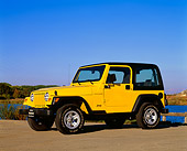 AUT 15 RK0394 01
2000 Jeep Wrangler Sport Hardtop Yellow 3/4 Side View On Pavement Blue Sky