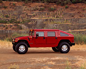 AUT 15 RK0396 02
2000 Hummer H1 Slantback Red 3/4 FrontView On Dirt By Quarry